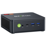 The image shows the GMKTEC NUBOX M5 Mini PC, a sleek and compact computing device. It has a modern design with a matte black finish. The front panel features several connectivity ports, including USB ports and an audio jack, and the GMKTEC logo is prominently displayed on the top. The overall design is minimalist, emphasizing portability and functionality for diverse computing tasks.