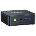 The image shows the GMKTEC NUBOX M5 Mini PC, a sleek and compact computing device. It has a modern design with a matte black finish. The front panel features several connectivity ports, including USB ports and an audio jack, and the GMKTEC logo is prominently displayed on the top. The overall design is minimalist, emphasizing portability and functionality for diverse computing tasks.