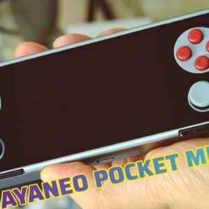 The AYANEO Pocket Micro handheld gaming device held in hands, showcasing its slim black design with a D-pad on the left, four red action buttons on the right, and two circular buttons below. The device's screen is off, and "AYANEO POCKET MICRO" text is overlaid at the bottom of the image.