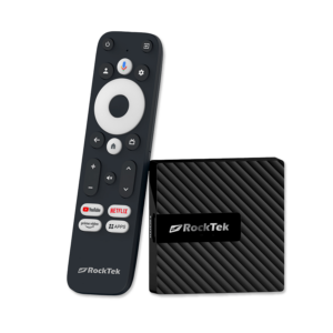 RockTek GB1 Android TV box shown alongside its dedicated remote control. The compact device has a sleek, textured design. The remote features a circular navigation pad, voice control button, and dedicated buttons for popular streaming services like YouTube, Netflix, and Prime Video, along with an 'Apps' button for quick access to installed applications