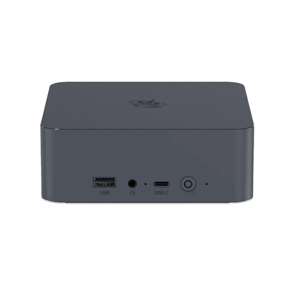 A straight on front view of a dark grey square shaped mini PC with rounded corners set against a solid dark green background The top surface has a subtle textured pattern and a circular logo The front panel features a USB A port a headphone jack a USB C port and a power button with a circular LED indicator All ports and buttons are labeled with white text