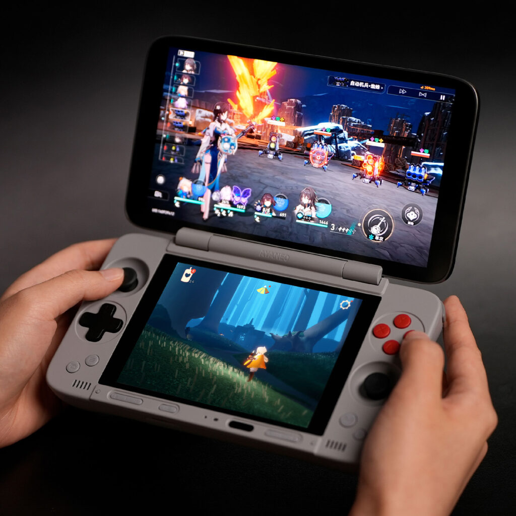 A person's hands holding the AYANEO Pocket DS, demonstrating the dual-screen functionality by playing two different games at once on the Android handheld.