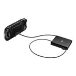 An angled shot of the GPD WIN 5 handheld gaming console from behind against a white background The device is connected via a black cable to a flat rectangular black dock or power bank This view highlights the devices back with its grips vents and a sticker with product information