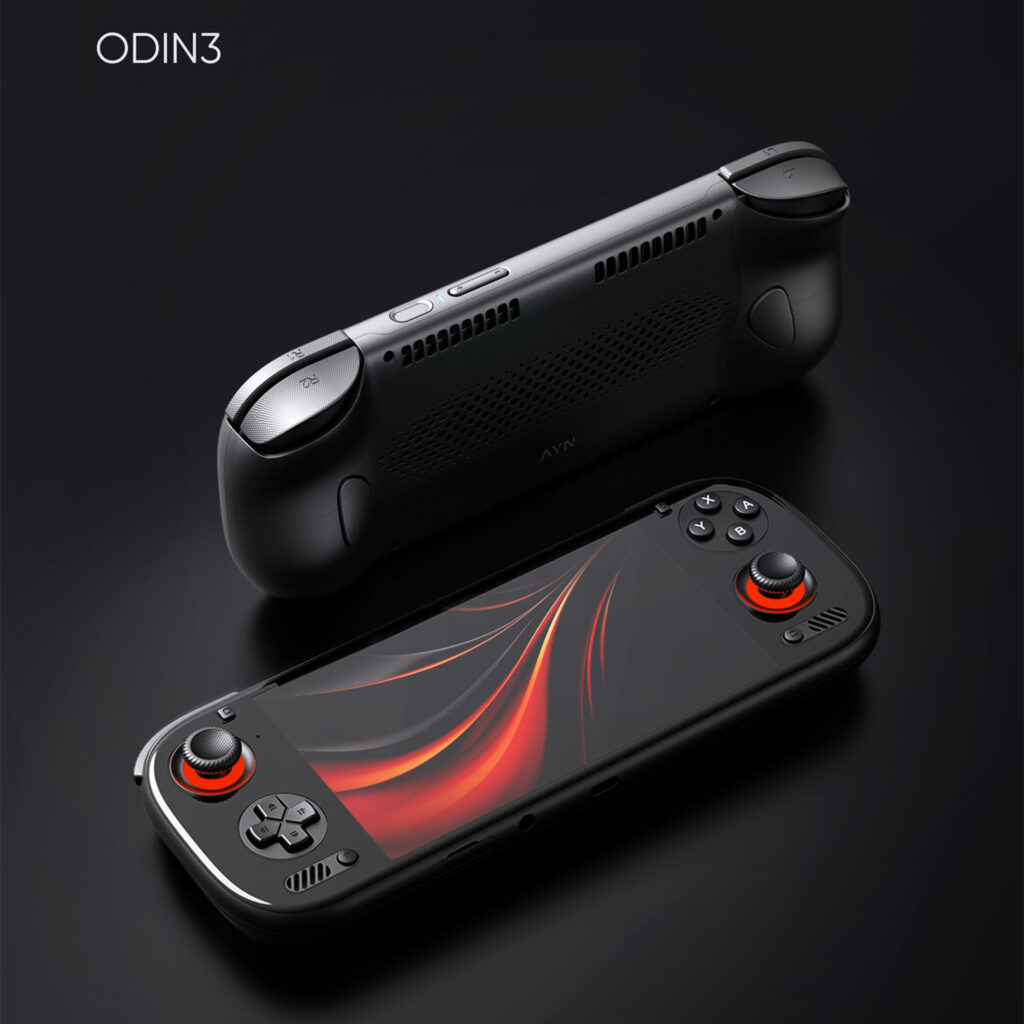 A pair of black AYN ODIN3 handheld gaming consoles is shown against a dark featureless background The foreground console is face up with its screen displaying a vibrant red and black abstract design Its joysticks are prominently lit with a glowing red ring The second console is positioned behind and above it flipped over to show the back of the device which features a textured grip and ventilation grilles The text ODIN3 is in the top left corner